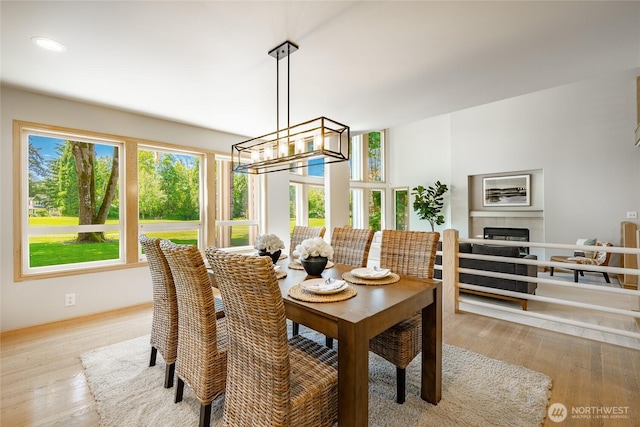 5520 Canvasback Rd, Blaine, WA 98230 - dining room with a chandelier, wood finished floors, and a tile fireplace