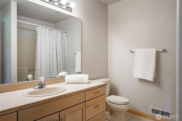 5520 Canvasback Rd, Blaine, WA 98230 - full bathroom with vanity, tile patterned flooring, toilet, and a shower with shower curtain