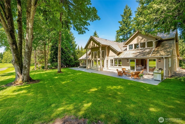 5520 Canvasback Rd, Blaine, WA 98230 - rear view of house featuring a patio, a yard, and an outdoor hangout area