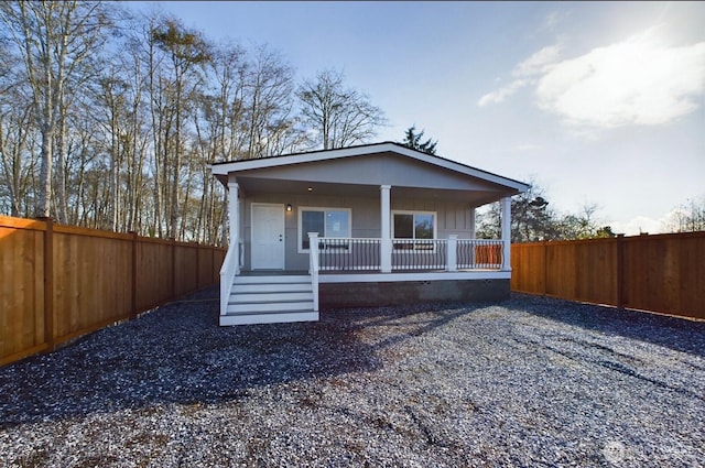 704 N 3rd St, Westport, WA 98595 - view of front of house featuring a porch and a fenced backyard