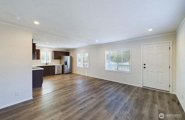 704 N 3rd St, Westport, WA 98595 - unfurnished living room with ornamental molding, a sink, dark wood-style flooring, recessed lighting, and baseboards