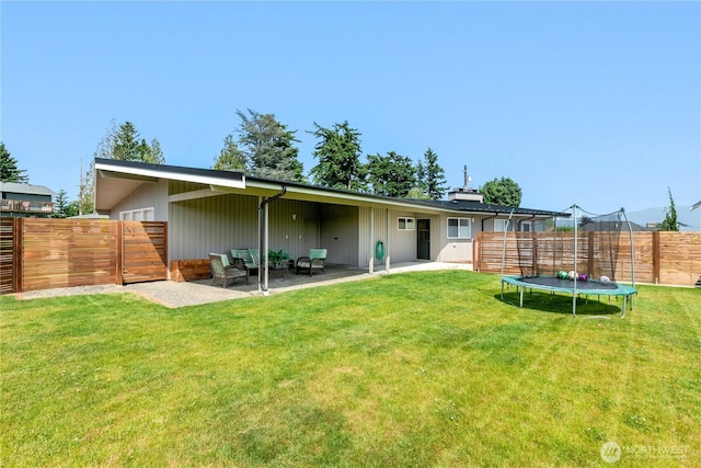 1101 Terrace Dr, Lynden, WA 98264 - rear view of house featuring a trampoline, a fenced backyard, and a patio area