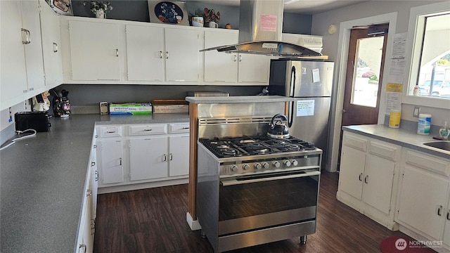 1402 22nd St NE Unit 252, Auburn, WA 98002 - kitchen featuring appliances with stainless steel finishes, island range hood, dark wood-style flooring, and white cabinets