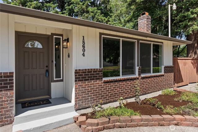 18604 9th Avenue Ct E, Spanaway, WA 98387 - view of exterior entry featuring brick siding and a chimney