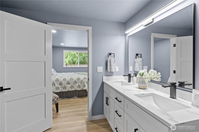 18604 9th Avenue Ct E, Spanaway, WA 98387 - bathroom featuring double vanity, wood finished floors, and connected bathroom