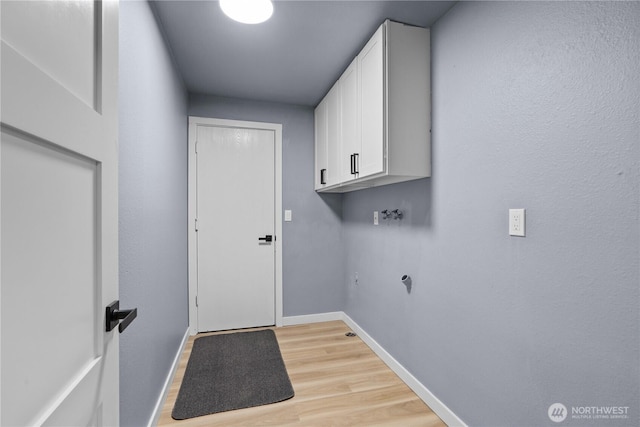 18604 9th Avenue Ct E, Spanaway, WA 98387 - laundry room with light wood-style floors, cabinet space, and washer hookup