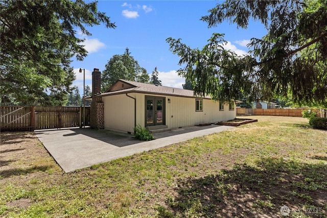 18604 9th Avenue Ct E, Spanaway, WA 98387 - back of property featuring french doors, a chimney, and a patio
