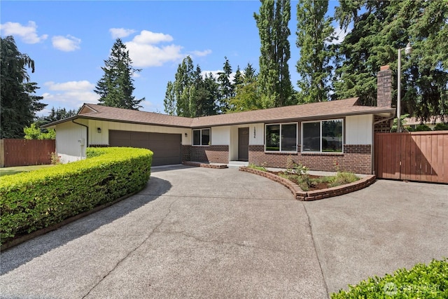 18604 9th Avenue Ct E, Spanaway, WA 98387 - ranch-style home featuring a chimney, brick siding, driveway, and a garage