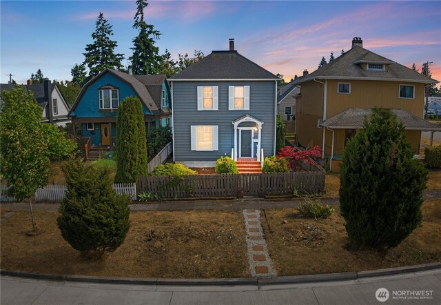 422 S Wright Ave, Tacoma, WA 98418 - view of front of home with a fenced front yard and a chimney