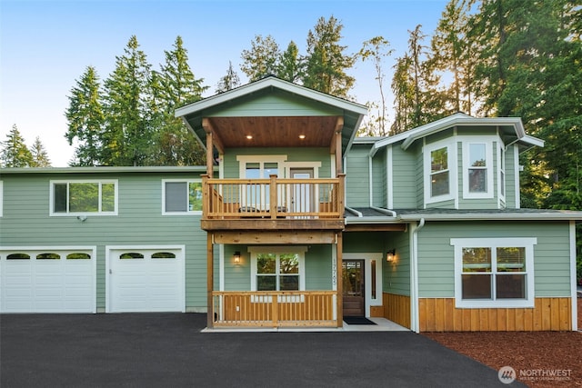 17765 25th Ave NE, Shoreline, WA 98155 - view of front of home featuring asphalt driveway, a balcony, and a garage