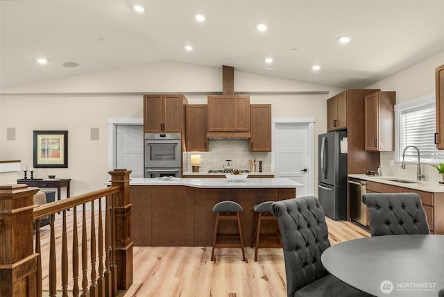 17765 25th Ave NE, Shoreline, WA 98155 - kitchen with appliances with stainless steel finishes, a sink, light wood-style floors, light countertops, and a breakfast bar