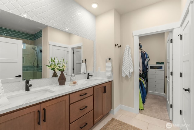 17765 25th Ave NE, Shoreline, WA 98155 - bathroom featuring double vanity, a stall shower, tile patterned floors, a walk in closet, and baseboards