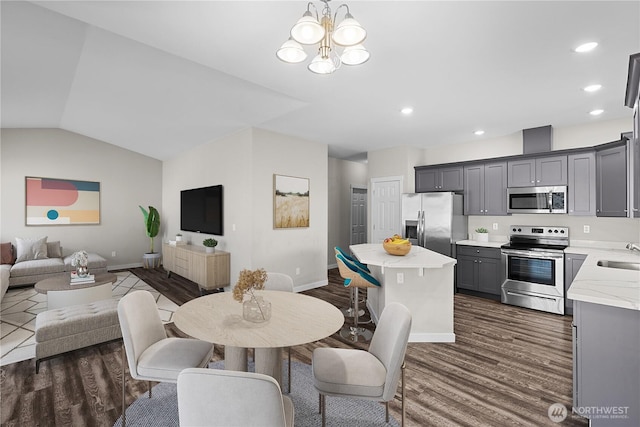 17621 Vine Ln SE, Yelm, WA 98597 - dining space featuring dark wood-type flooring, a chandelier, recessed lighting, and lofted ceiling