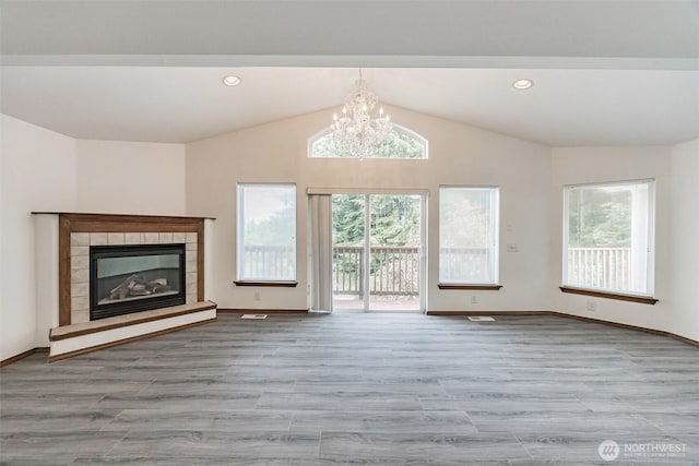 5 Bayview Ln, Hoquiam, WA 98550 - unfurnished living room featuring wood finished floors, a chandelier, vaulted ceiling, a fireplace, and baseboards
