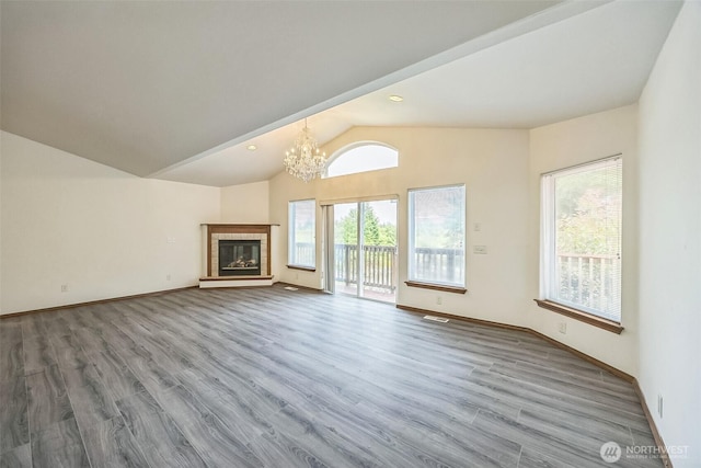 5 Bayview Ln, Hoquiam, WA 98550 - unfurnished living room with vaulted ceiling, a chandelier, healthy amount of natural light, wood finished floors, and baseboards