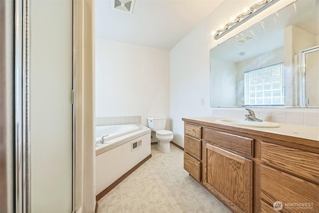 5 Bayview Ln, Hoquiam, WA 98550 - bathroom featuring vanity, toilet, a garden tub, baseboards, and an enclosed shower