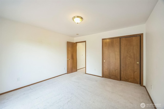 5 Bayview Ln, Hoquiam, WA 98550 - unfurnished bedroom featuring light carpet, a closet, and baseboards
