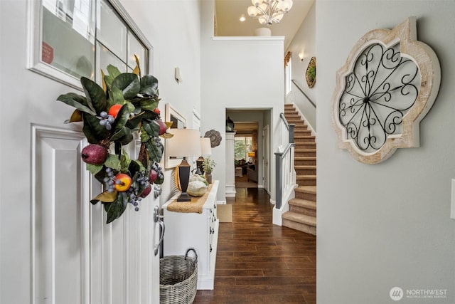 19409 90th Avenue Ct E, Graham, WA 98338 - entryway with stairs, dark wood-type flooring, a high ceiling, a chandelier, and baseboards