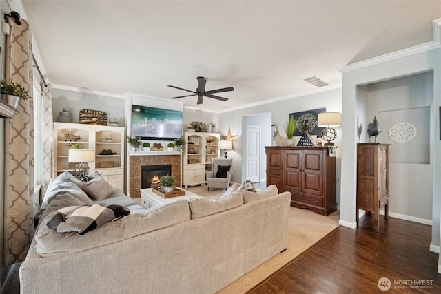 19409 90th Avenue Ct E, Graham, WA 98338 - living area featuring dark wood finished floors, a fireplace, crown molding, a ceiling fan, and baseboards