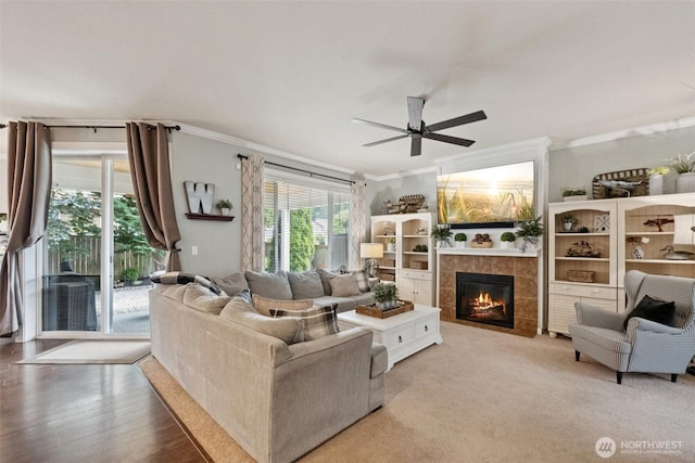 19409 90th Avenue Ct E, Graham, WA 98338 - living room featuring ornamental molding, a tiled fireplace, and a ceiling fan
