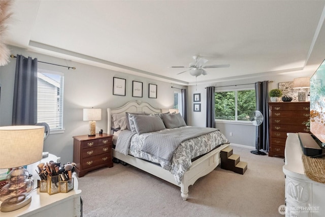 19409 90th Avenue Ct E, Graham, WA 98338 - bedroom featuring light colored carpet, a ceiling fan, and a raised ceiling