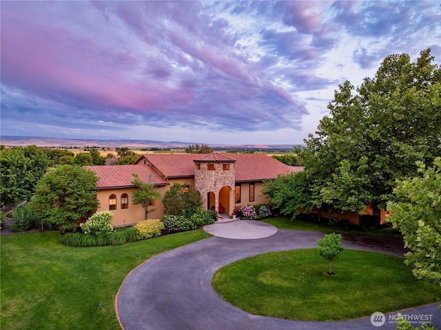 2316 Ridgeview Rd, Walla Walla, WA 99362 - mediterranean / spanish house with curved driveway, stucco siding, a front lawn, a tile roof, and stone siding