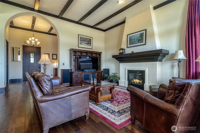 2316 Ridgeview Rd, Walla Walla, WA 99362 - living room with arched walkways, hardwood / wood-style floors, a chandelier, a glass covered fireplace, and beam ceiling