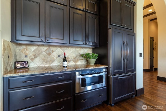 2316 Ridgeview Rd, Walla Walla, WA 99362 - kitchen with paneled built in fridge, oven, dark wood-style floors, arched walkways, and backsplash
