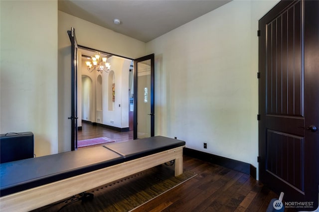 2316 Ridgeview Rd, Walla Walla, WA 99362 - unfurnished bedroom featuring dark wood-style flooring, a chandelier, arched walkways, and an office area