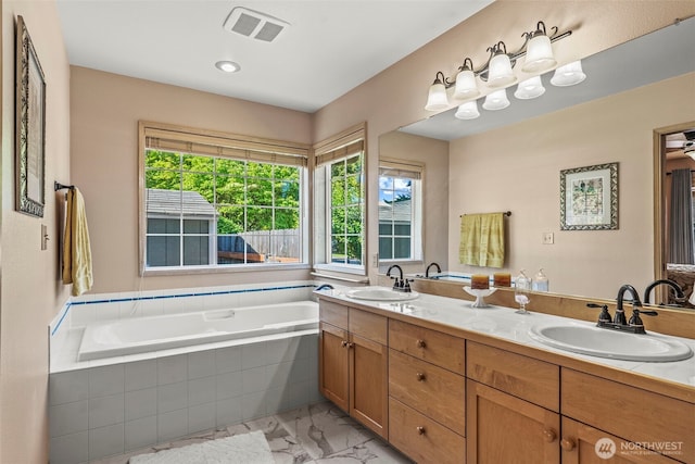 2951 Premiere Pl, Longview, WA 98632 - bathroom with marble look tile flooring, double vanity, and a bath