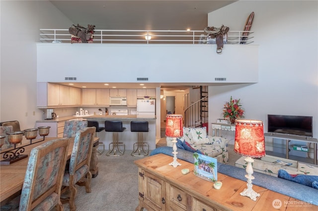 103 N Park St Unit 341, Chelan, WA 98816 - living area featuring light colored carpet, stairway, and a towering ceiling