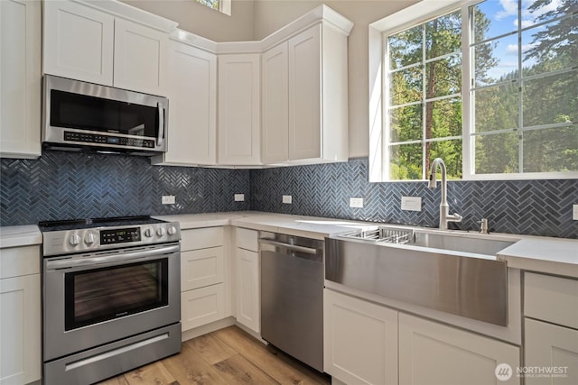 10642 Merry Canyon Rd, Leavenworth, WA 98820 - kitchen featuring stainless steel appliances, light countertops, white cabinets, and tasteful backsplash