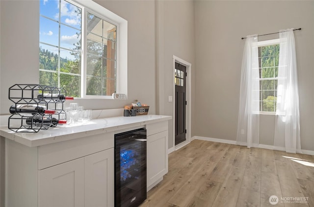 10642 Merry Canyon Rd, Leavenworth, WA 98820 - indoor dry bar featuring wine cooler, plenty of natural light, light wood-style flooring, and baseboards