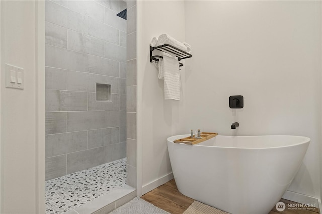 10642 Merry Canyon Rd, Leavenworth, WA 98820 - full bathroom with walk in shower, a freestanding tub, baseboards, and wood finished floors