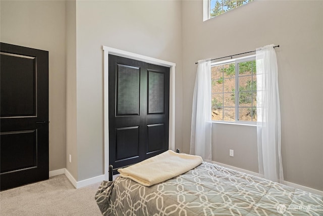 10642 Merry Canyon Rd, Leavenworth, WA 98820 - carpeted bedroom with multiple windows, baseboards, and a high ceiling