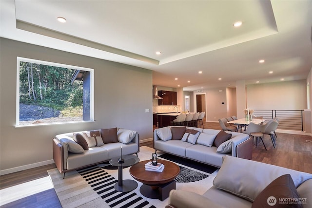 17615 142nd Ave E Unit 14, Puyallup, WA 98374 - living room featuring a raised ceiling, baseboards, wood finished floors, and recessed lighting