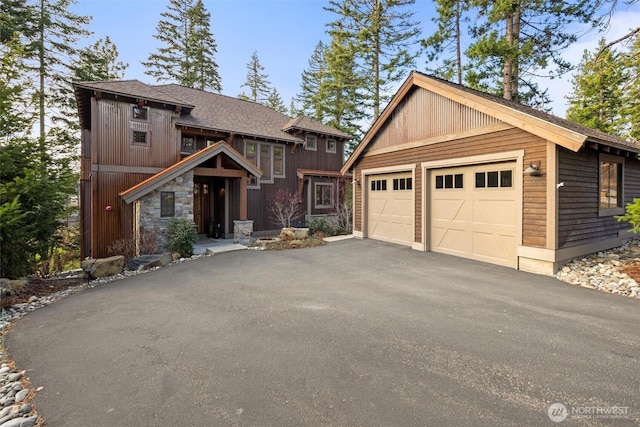 420 Black Nugget Ln, Cle Elum, WA 98922 - view of front facade with an outdoor structure, a garage, and stone siding