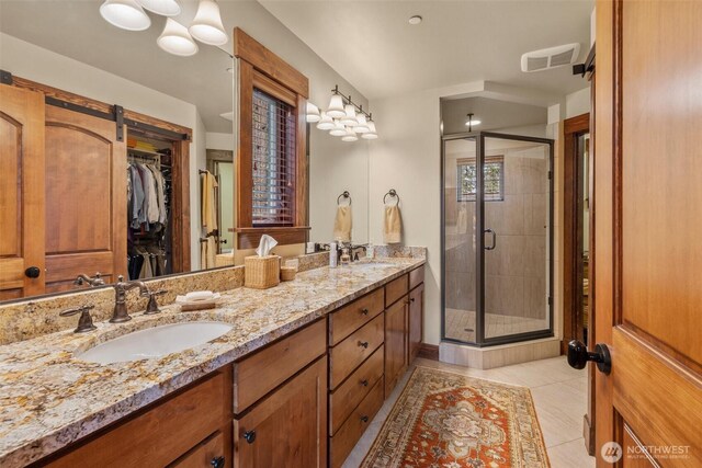 420 Black Nugget Ln, Cle Elum, WA 98922 - bathroom featuring double vanity, a shower stall, a spacious closet, and tile patterned flooring