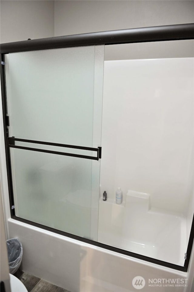 613 Aster Ct SE, Ocean Shores, WA 98569 - full bath with combined bath / shower with glass door, toilet, and wood finished floors