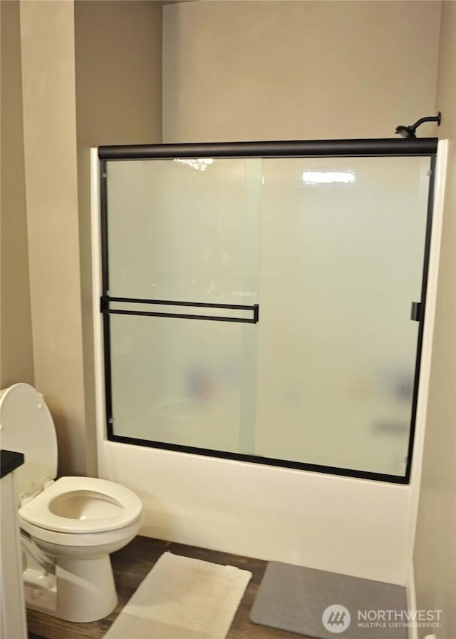 613 Aster Ct SE, Ocean Shores, WA 98569 - full bath with wood finished floors, toilet, and enclosed tub / shower combo