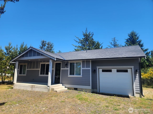 613 Aster Ct SE, Ocean Shores, WA 98569 - single story home with a garage, covered porch, a shingled roof, and a front lawn
