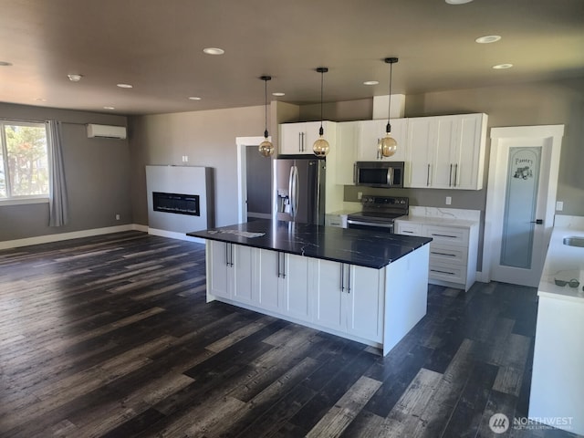 613 Aster Ct SE, Ocean Shores, WA 98569 - kitchen featuring stainless steel appliances, dark wood-type flooring, a wall mounted AC, white cabinetry, and recessed lighting