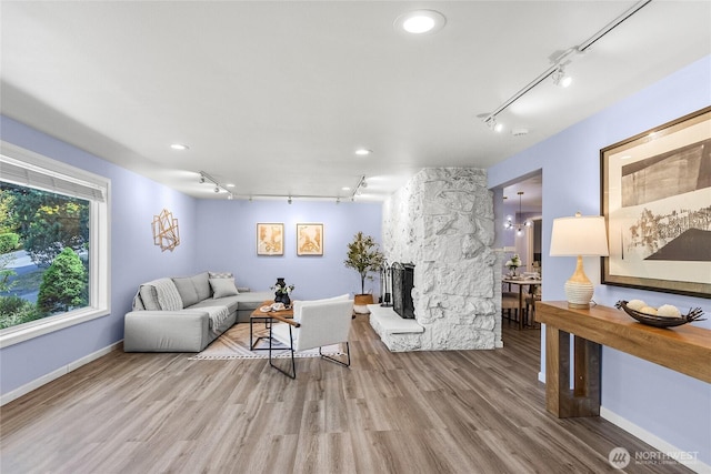 2463 74th Ave SE, Mercer Island, WA 98040 - living area with rail lighting, wood finished floors, a stone fireplace, and recessed lighting