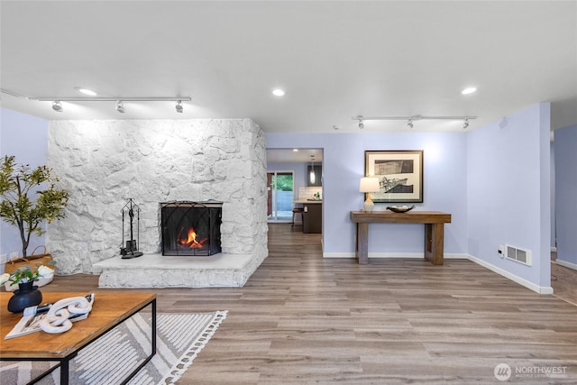 2463 74th Ave SE, Mercer Island, WA 98040 - living area featuring track lighting, wood finished floors, and a fireplace