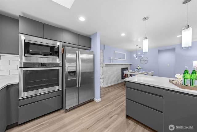2463 74th Ave SE, Mercer Island, WA 98040 - kitchen featuring appliances with stainless steel finishes, gray cabinetry, light countertops, decorative light fixtures, and recessed lighting