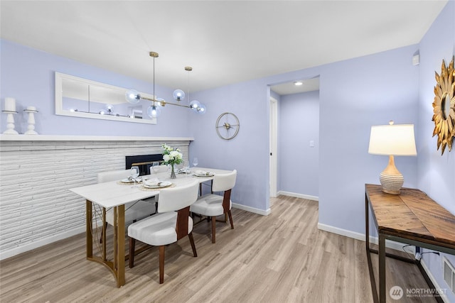 2463 74th Ave SE, Mercer Island, WA 98040 - dining room featuring wood finished floors and a glass covered fireplace