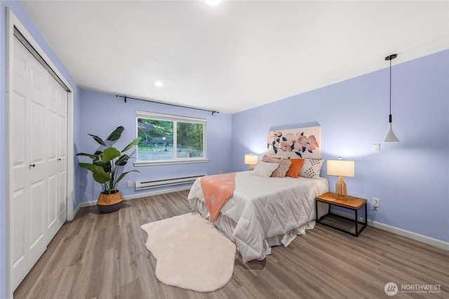 2463 74th Ave SE, Mercer Island, WA 98040 - bedroom featuring a baseboard radiator, wood finished floors, a closet, and recessed lighting