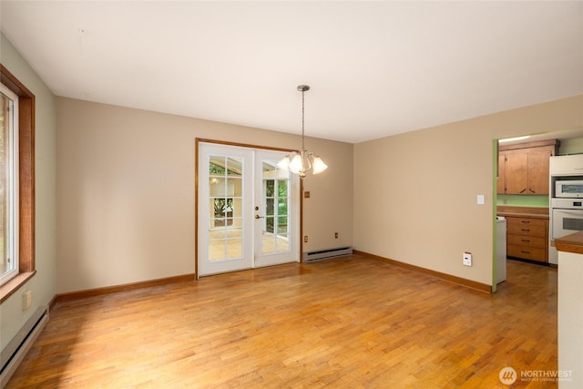 7823 Parker Rd, Sedro Woolley, WA 98284 - unfurnished room with a baseboard heating unit, light wood-style floors, a chandelier, and french doors
