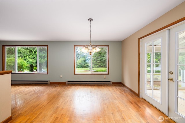 7823 Parker Rd, Sedro Woolley, WA 98284 - spare room with a baseboard heating unit, a chandelier, and light wood-style flooring