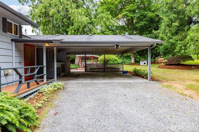 7823 Parker Rd, Sedro Woolley, WA 98284 - view of parking featuring gravel driveway, an attached carport, and view of scattered trees